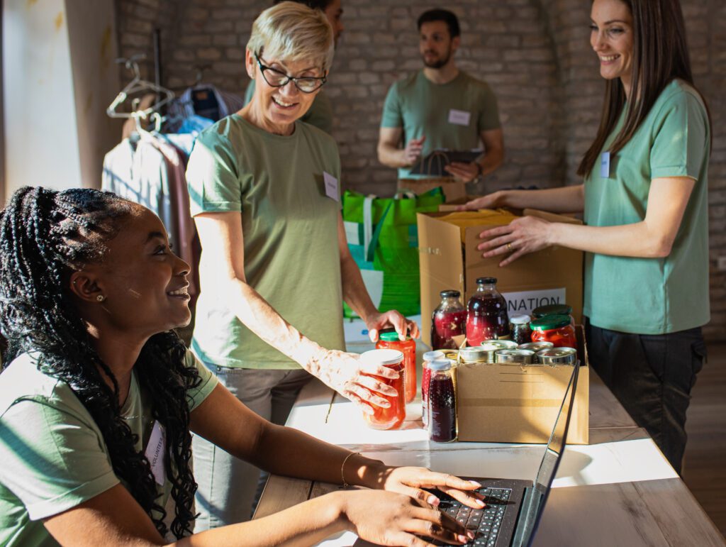 Volunteers collaborating to sort food donations and manage logistics at a food bank.